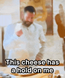 a man with a beard says " this cheese has a hold on me " in front of a table