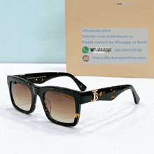 a pair of burberry sunglasses sits in front of a box