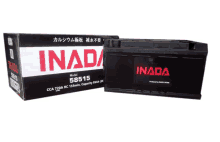 a black inada battery sits next to a box