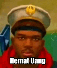 a close up of a man wearing a hat and a red jacket with the words hemat uang written on it .