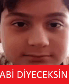 a close up of a boy 's face with the words abi diyecaksin written on the bottom