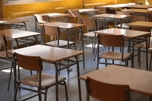 a row of empty classroom tables and chairs