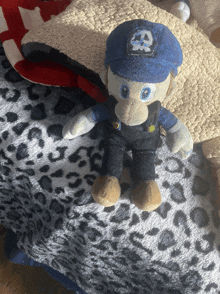 a stuffed animal with the letter a on it 's hat