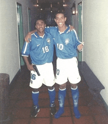 two soccer players are posing for a picture and one has the number 10 on his shirt