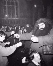 a man with a beard is standing in front of a crowd