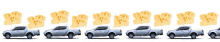 a row of silver pickup trucks with cheese pieces in the back