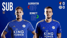 two soccer players wearing blue shirts with king power on them