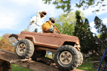 two stuffed animals are riding in a toy jeep with tires that say ' tonka '