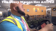 a man with a beard is driving a golf cart with the words the pussy wagon has arrived above him