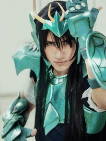 a man with long black hair and a green armored costume