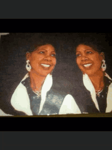 two women are smiling for a picture and one is wearing white earrings