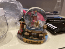 a small snow globe with the word stockholm on it sits on a table