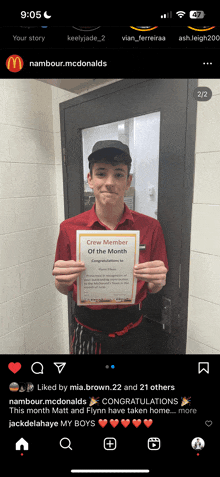 a young man in a red shirt is holding a certificate that says ' chef member of the month '