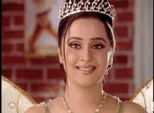 a woman is wearing a tiara and a necklace .