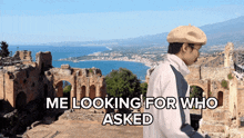 a man in a hat stands in front of ruins with the words " me looking for who asked " above him