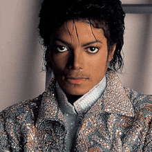 a close up of a man 's face wearing a jacket with sequins