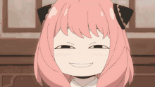 a cartoon girl with pink hair and black ears makes a funny face