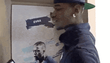 a man standing in front of a poster that says evra on it