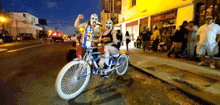 a man and woman wearing masks are riding a bike