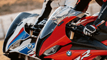 two bmw motorcycles are parked next to each other on a track