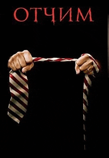 a man is holding a tie in his hand on a black background .