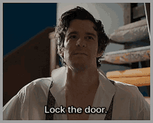 a man in a white shirt with the words lock the door behind him