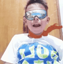 a young boy wearing sunglasses and a shirt that says lion on it