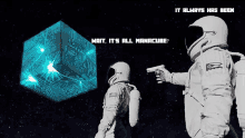 two astronauts are standing in front of a blue cube and the words wait it 's all manacube