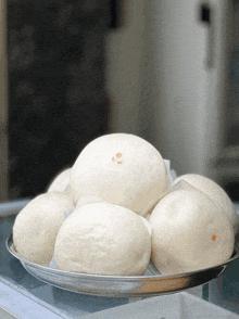 a bunch of white balls are on a silver tray