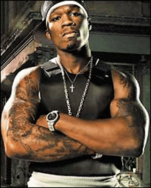 a man with a lot of tattoos on his arms is standing with his arms crossed and wearing a watch .