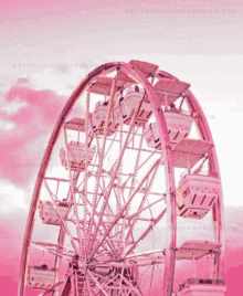 a pink ferris wheel with the website aestheticdesignshop.com on the bottom right