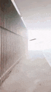 a person is walking down a hallway with a skateboard in the air