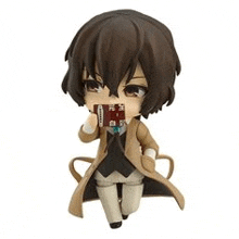 a chibi figure of a person holding a book in their hand .