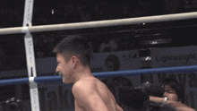 a boxer 's back is shown in a boxing ring with a sign behind him that says ' victory '