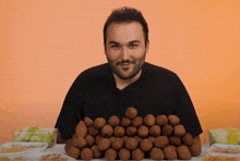 a man sitting in front of a pile of food