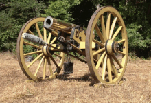 a cannon with the letter d on it is in a field