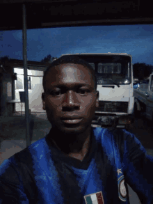 a man wearing a blue and black shirt with a star on the front