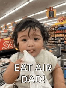 a baby is sitting in a shopping cart in a grocery store eating a piece of paper .