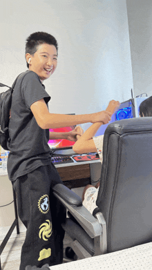 a boy wearing a black shirt with the word galaxy on the pants