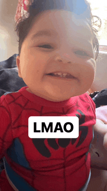 a baby wearing a red spiderman shirt with the word lmao written on it