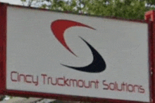 a sign for cincy truckmount solutions has a red and black s on it