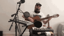 a man playing a guitar in front of a keyboard and a microphone with the word pro on his hat