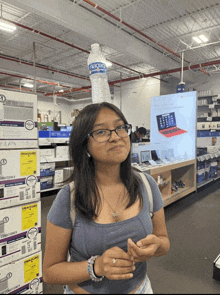 a woman in a store with a water bottle on her head