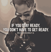 a man wearing sunglasses and gloves smoking a cigarette with a motivation mafia quote