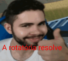 a man with a beard is giving a thumbs up with the words " a rotatoria resolve " behind him