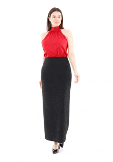 a woman in a red top and black skirt