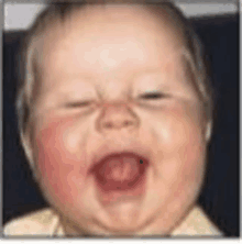 a baby with red cheeks is making a funny face with his mouth open .