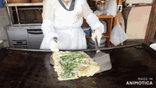 a woman in a white apron is cooking food on a griddle with the words made in animotica at the bottom