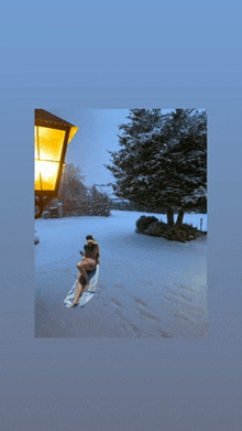 a couple laying on a towel in a snowy yard