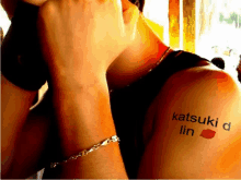 a person with a tattoo on their shoulder that says katsuki lin